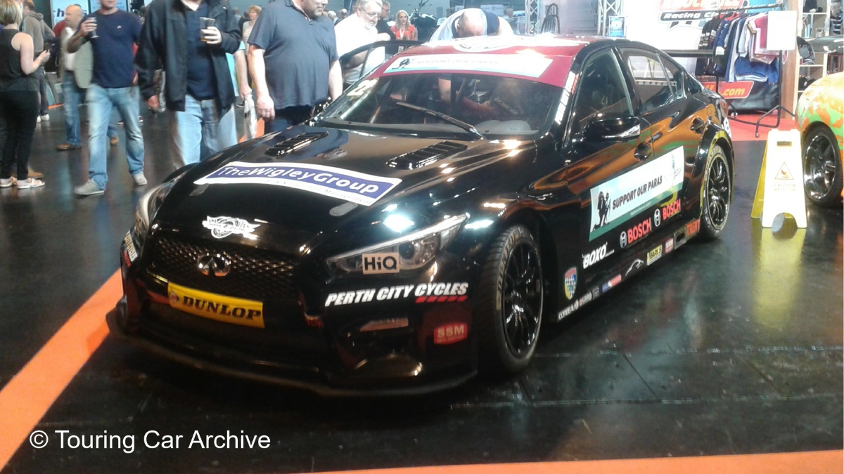 Front 3/4 photo of a black Infiniti Q50 on display indoors in an event hall
